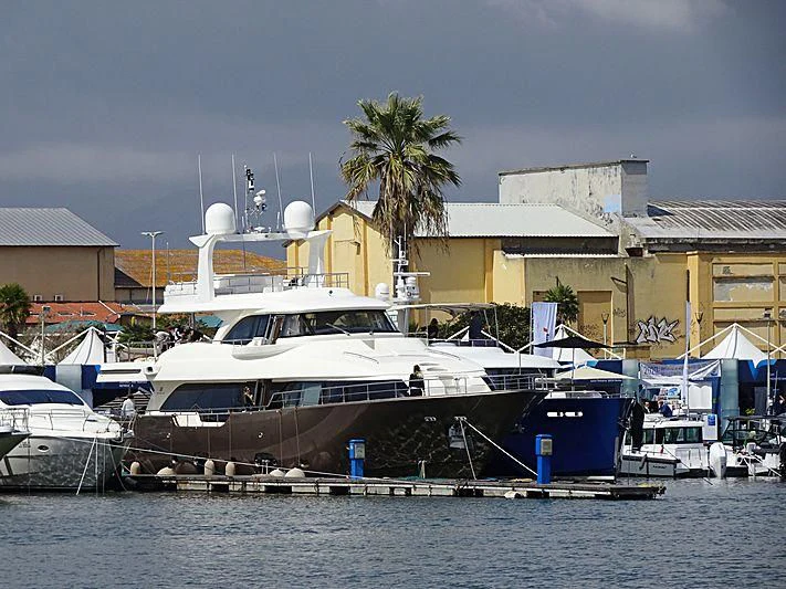 a boat docked at a pier aboard DISPARATE Yacht for Sale