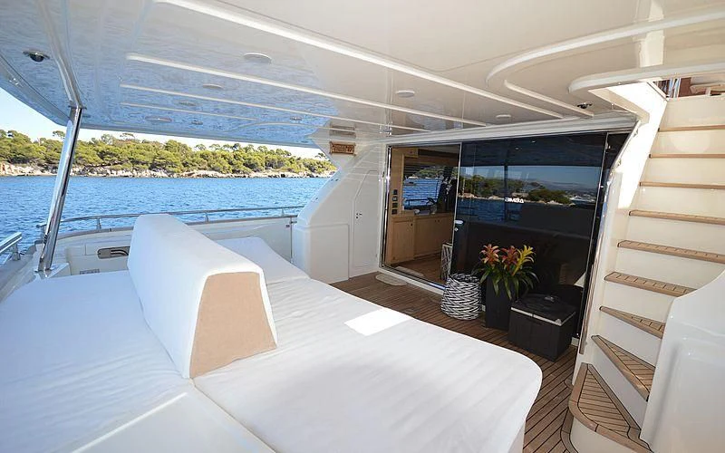 a boat with a large white bed aboard DISPARATE Yacht for Sale