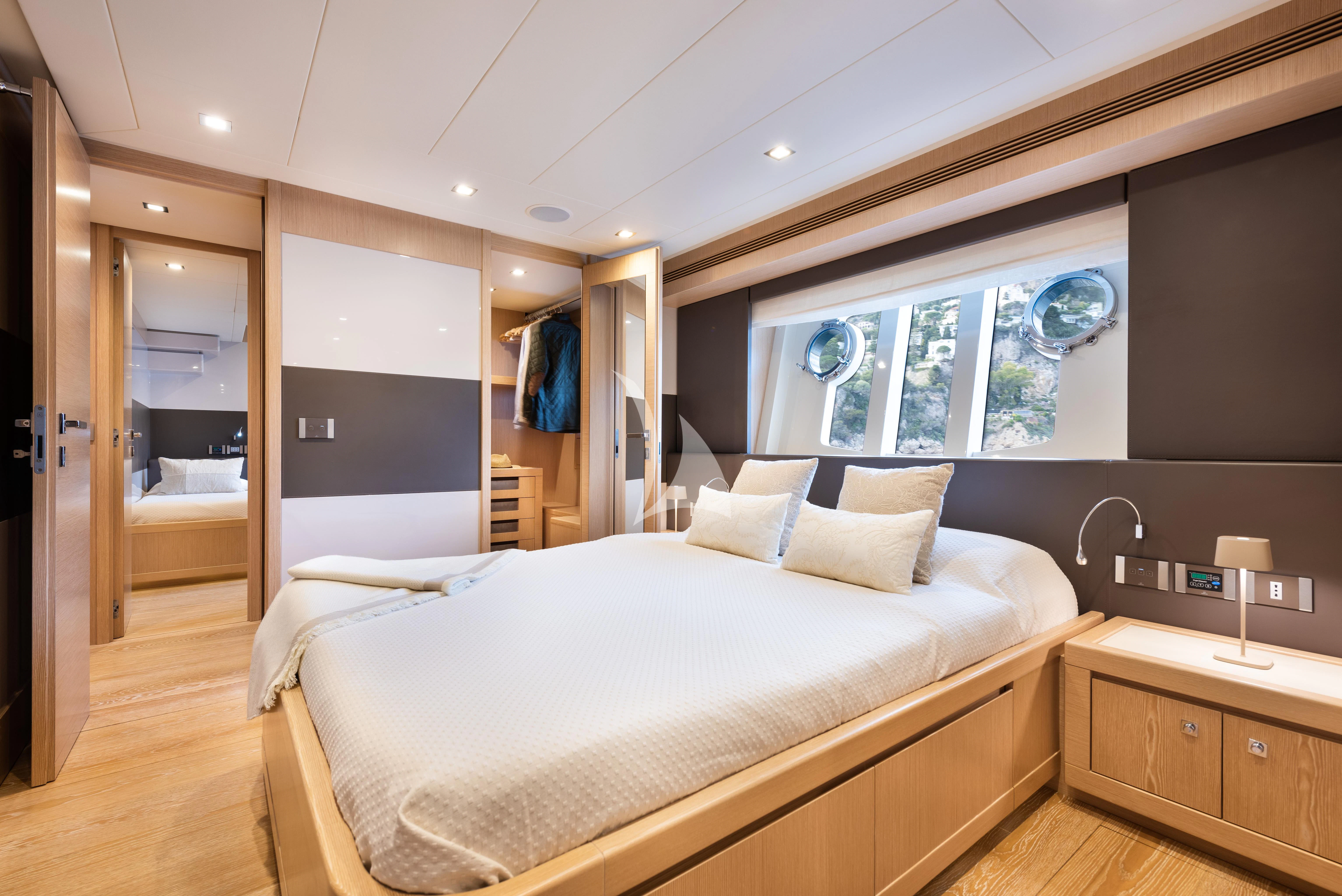 a bedroom with a large bed aboard DISPARATE Yacht for Sale