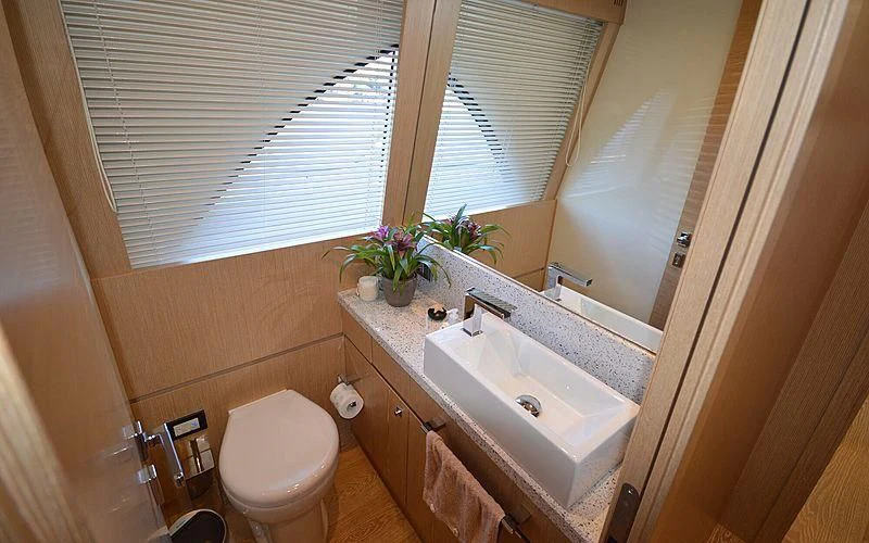 a bathroom with a sink and a toilet aboard DISPARATE Yacht for Sale