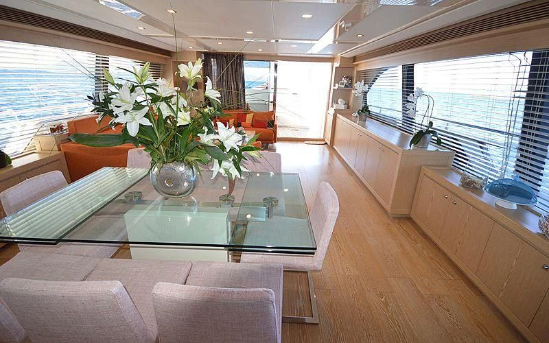 a living room with a table and chairs aboard DISPARATE Yacht for Sale