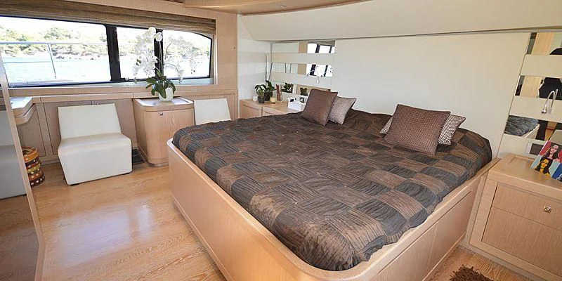 a bedroom with a large bed aboard DISPARATE Yacht for Sale