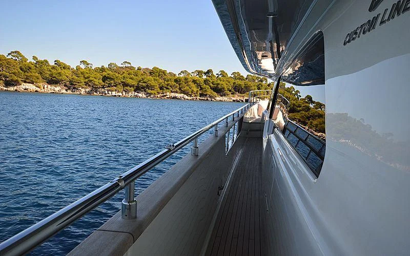 a dock with a body of water and trees in the background aboard DISPARATE Yacht for Sale