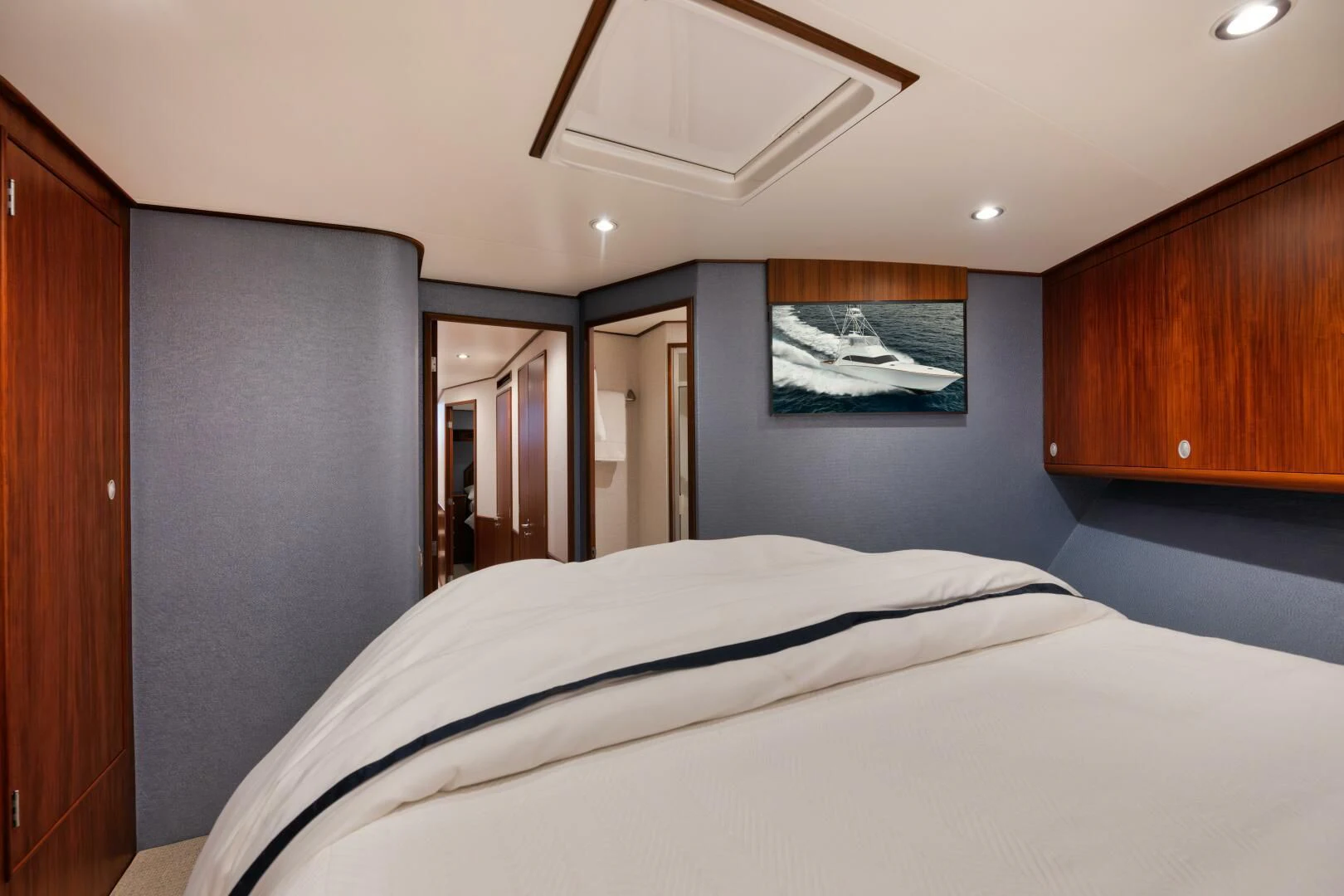 a bedroom with a bed and a mirror aboard W Yacht for Sale