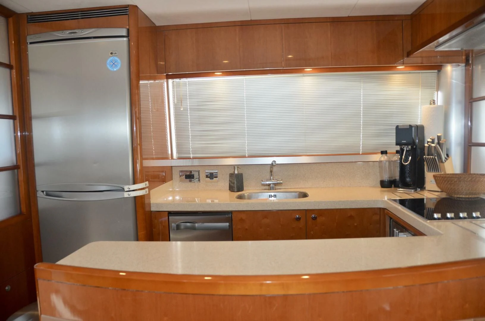 a kitchen with a stainless steel refrigerator aboard W Yacht for Sale