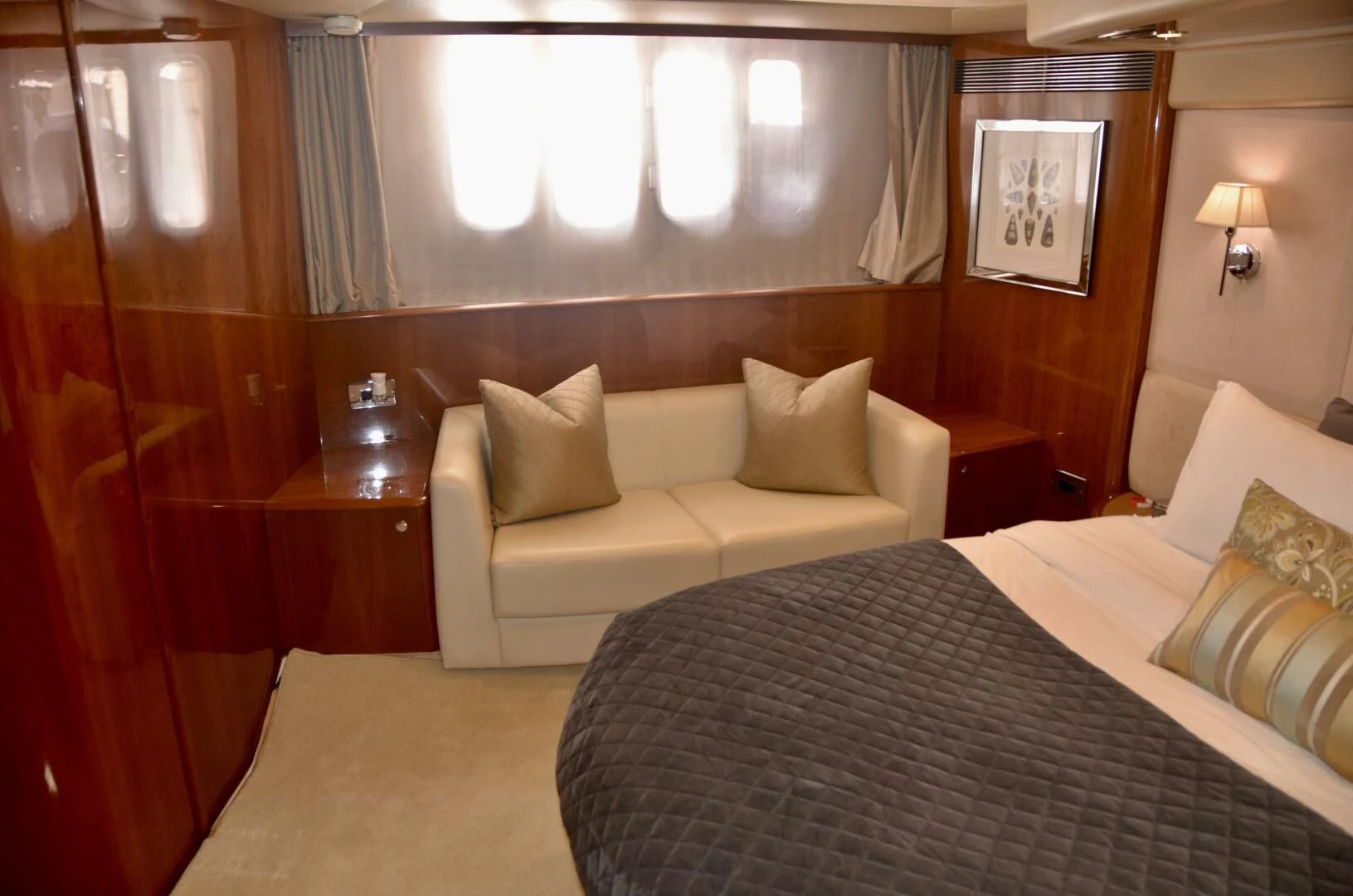 a hotel room with a bed and a couch aboard W Yacht for Sale