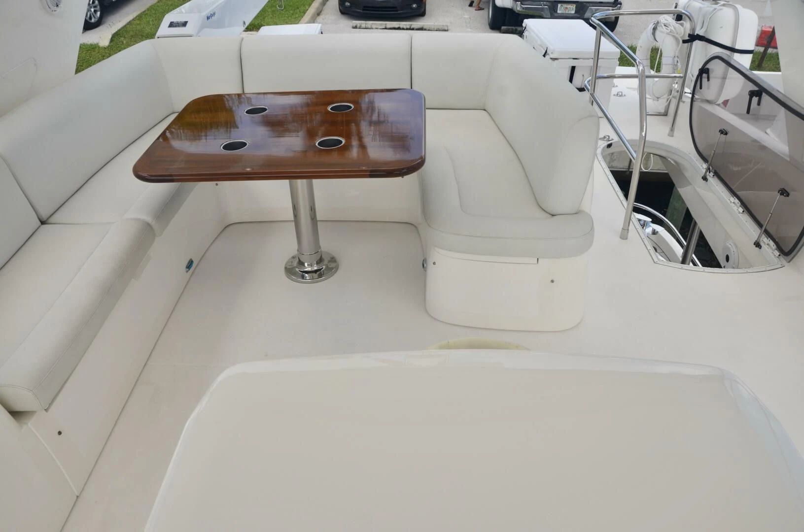 a wooden table on a white couch aboard W Yacht for Sale