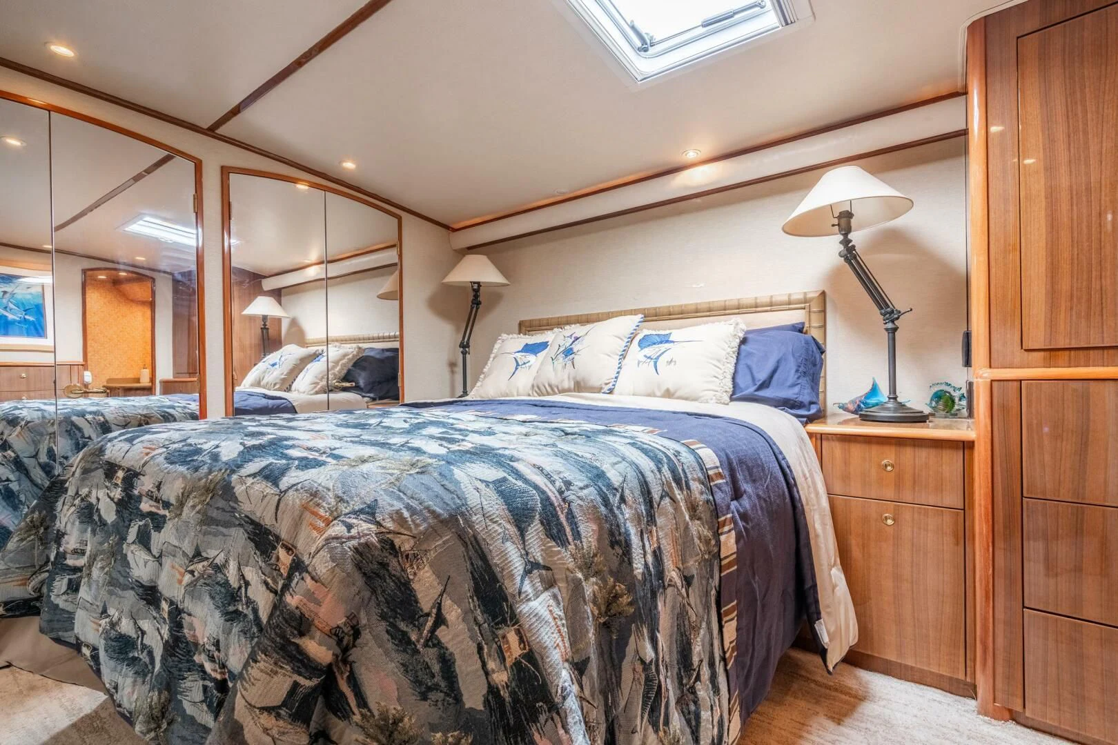 a bedroom with a bed and a lamp aboard W Yacht for Sale
