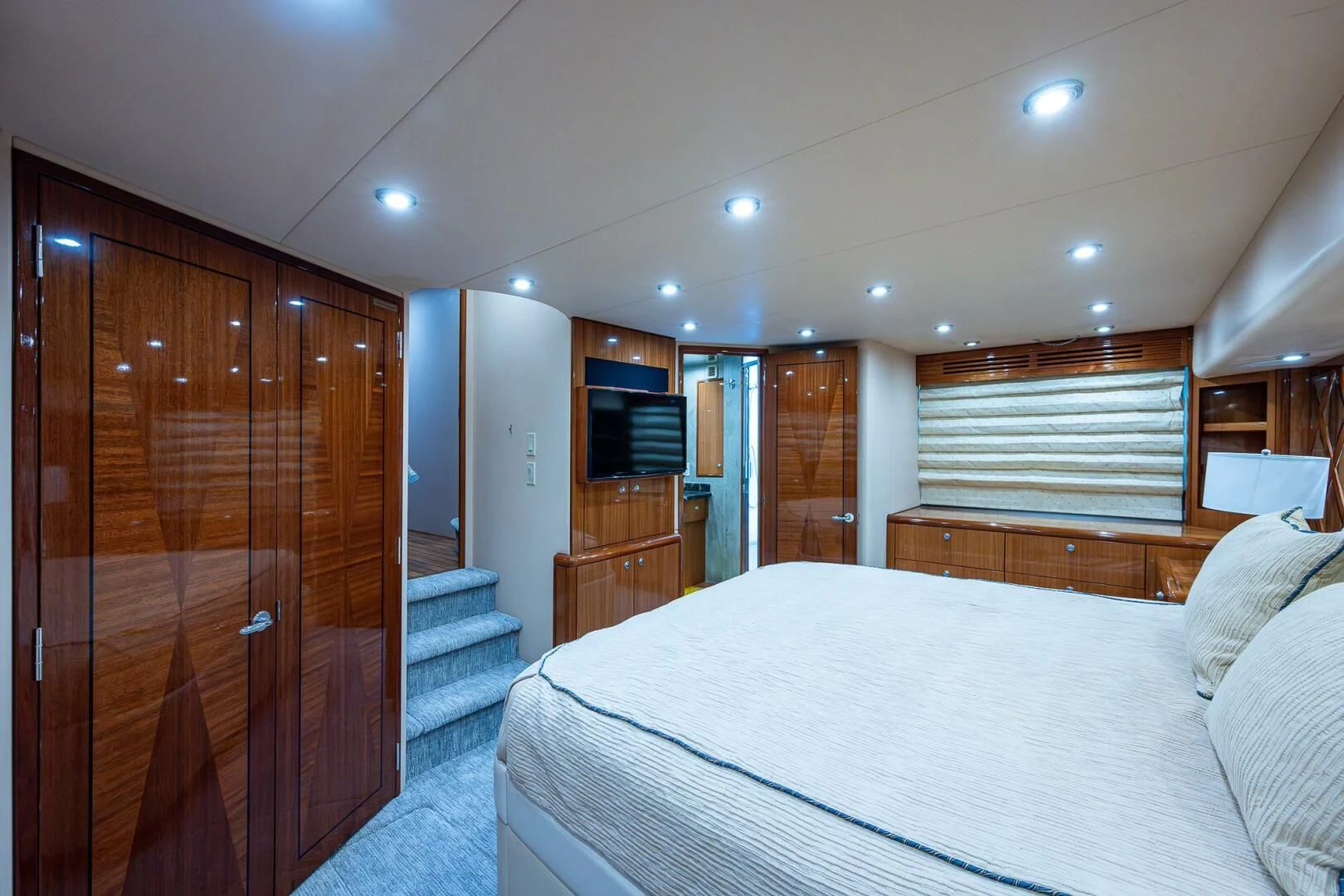 a bedroom with a bed and a closet aboard W Yacht for Sale