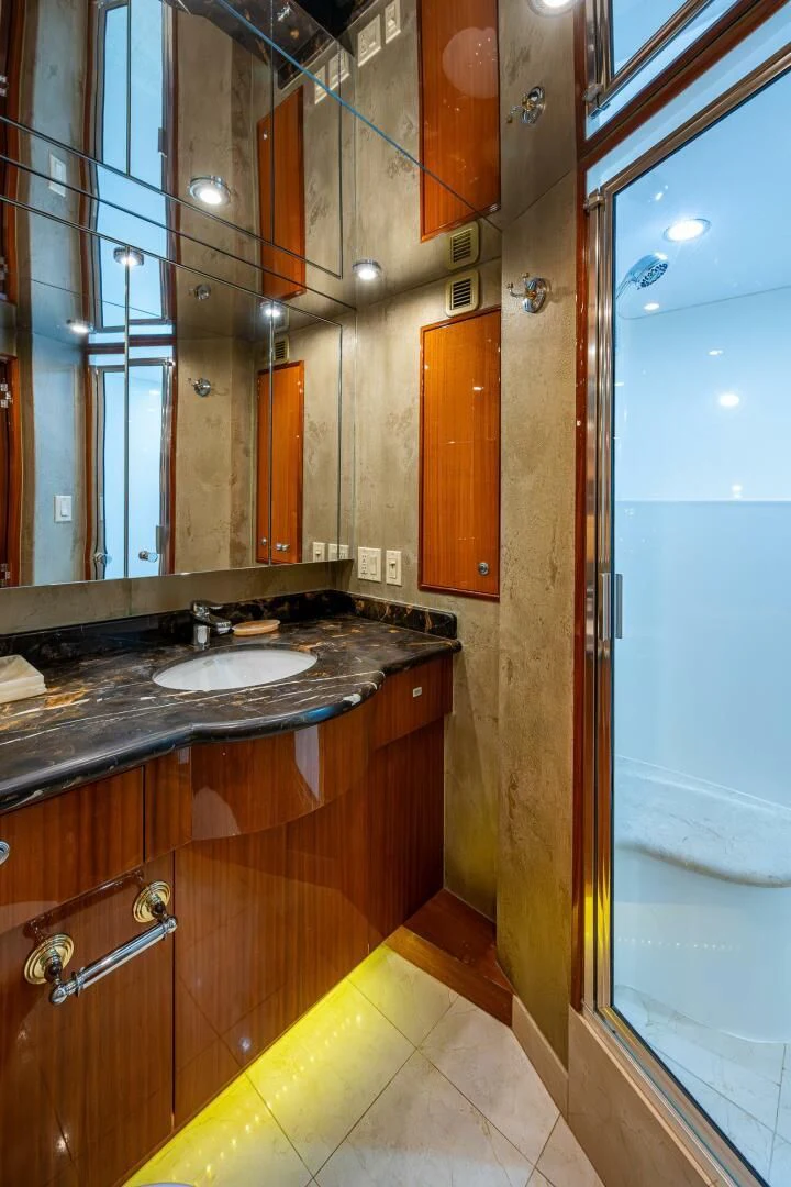 a bathroom with a sink and a mirror aboard W Yacht for Sale