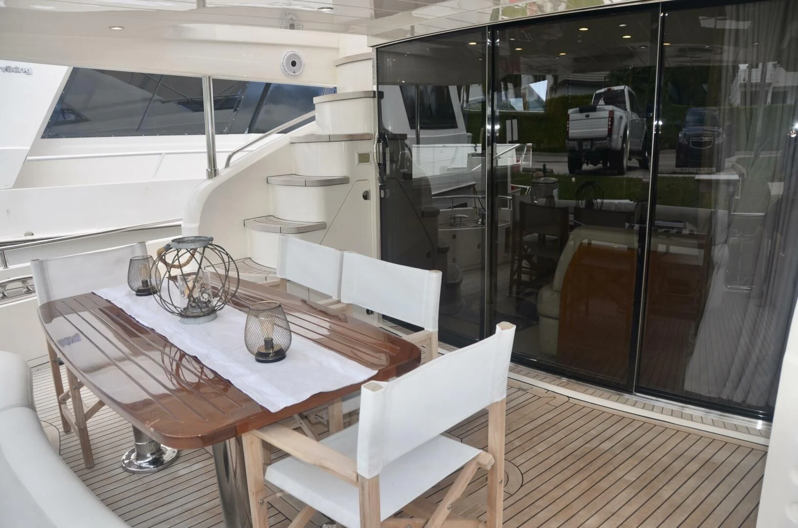 a dining table and chairs in a room with glass doors aboard W Yacht for Sale