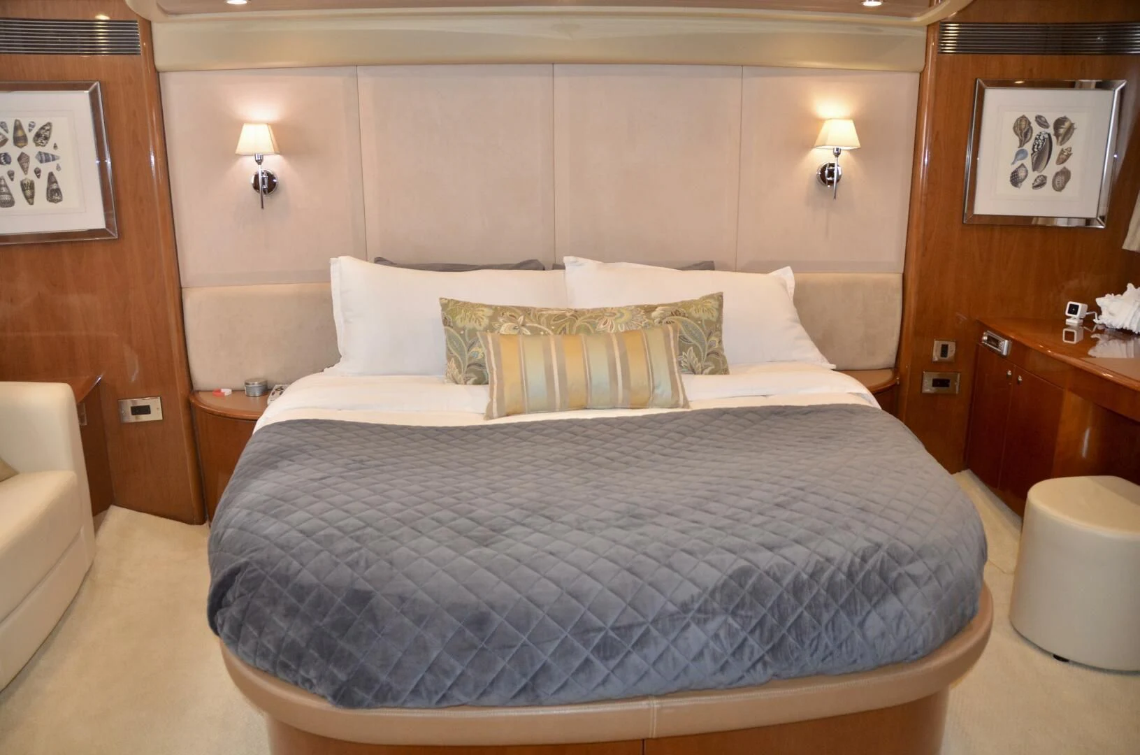 a bed with a blue and white comforter and pillows aboard W Yacht for Sale