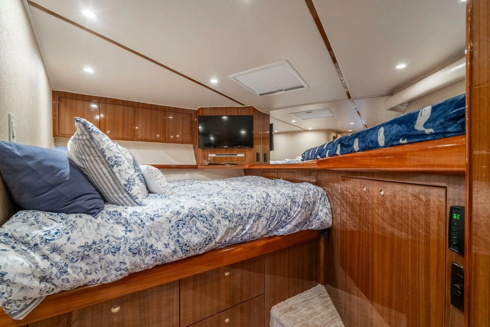 a bed with a television on the wall aboard W Yacht for Sale