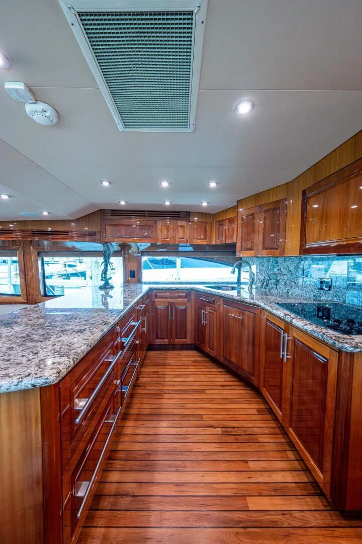 a kitchen with wooden cabinets aboard W Yacht for Sale