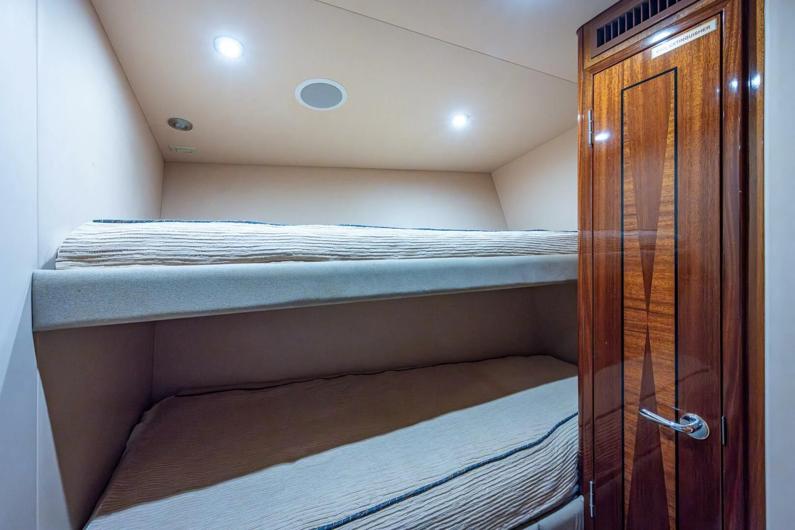 a bed with a wooden wardrobe aboard W Yacht for Sale