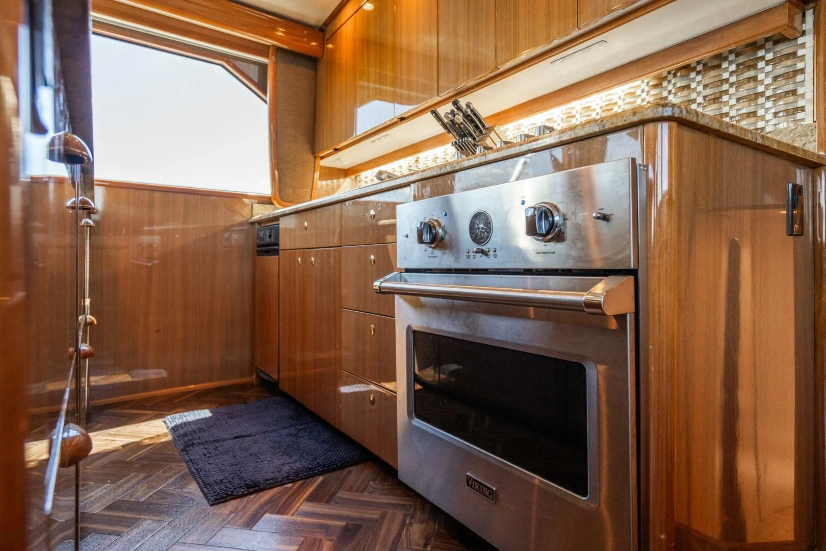 a kitchen with wooden cabinets aboard W Yacht for Sale