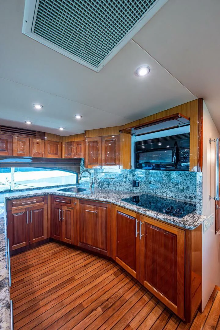 a kitchen with wooden cabinets aboard W Yacht for Sale