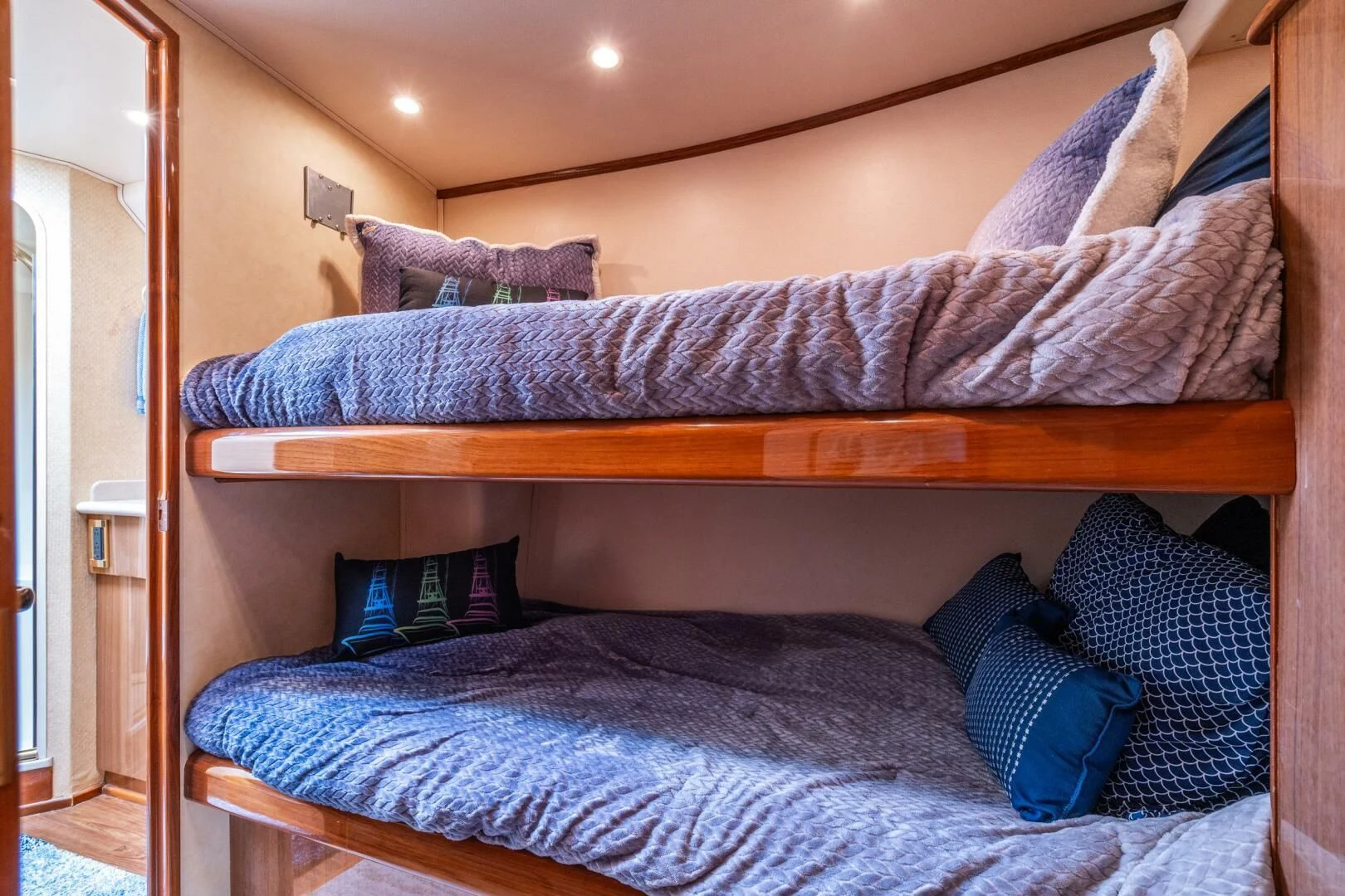 a bed with blue pillows aboard W Yacht for Sale