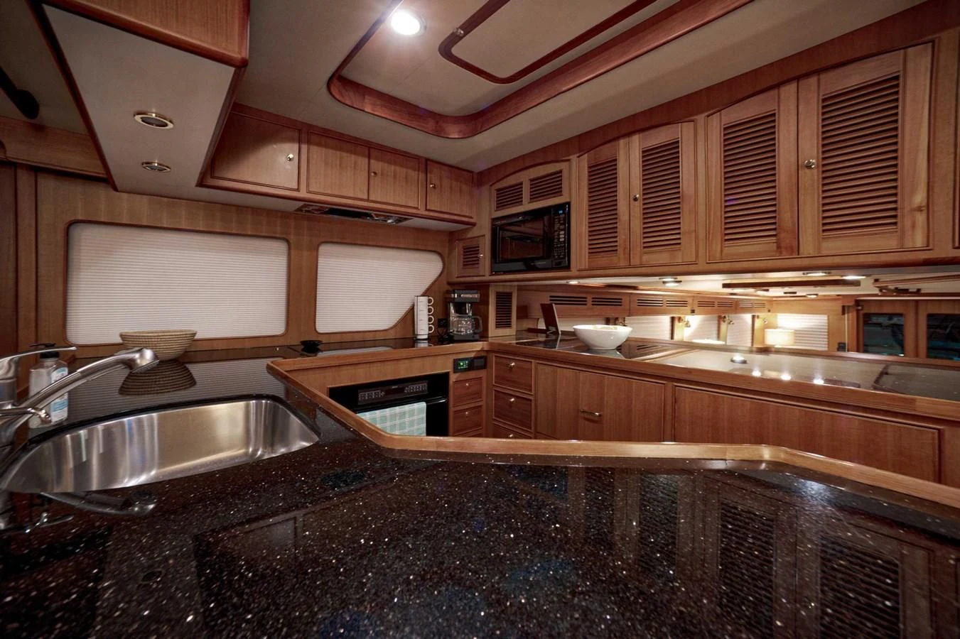 a kitchen with wooden cabinets aboard JUBILEE Yacht for Sale
