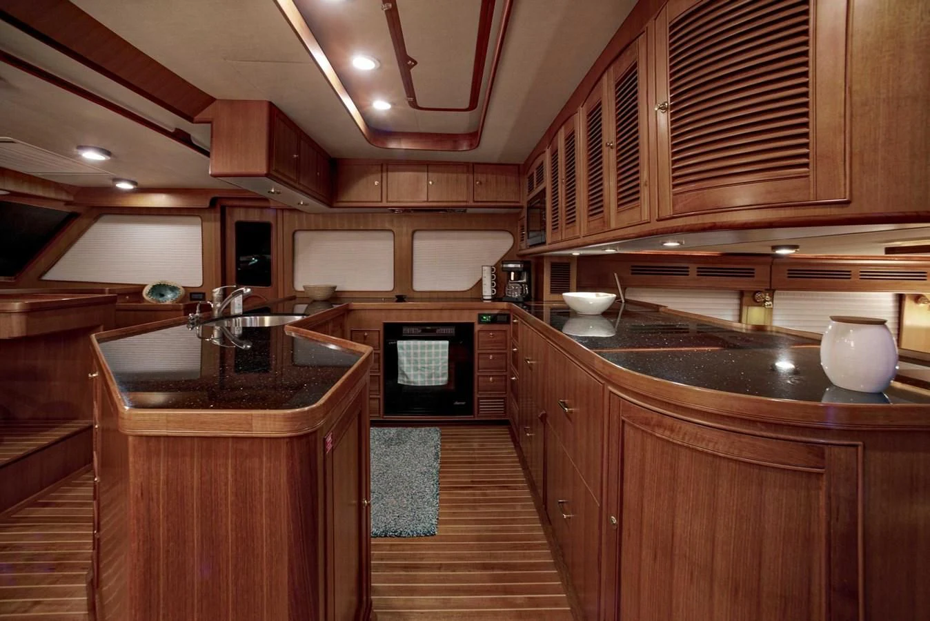 a kitchen with wooden cabinets aboard JUBILEE Yacht for Sale