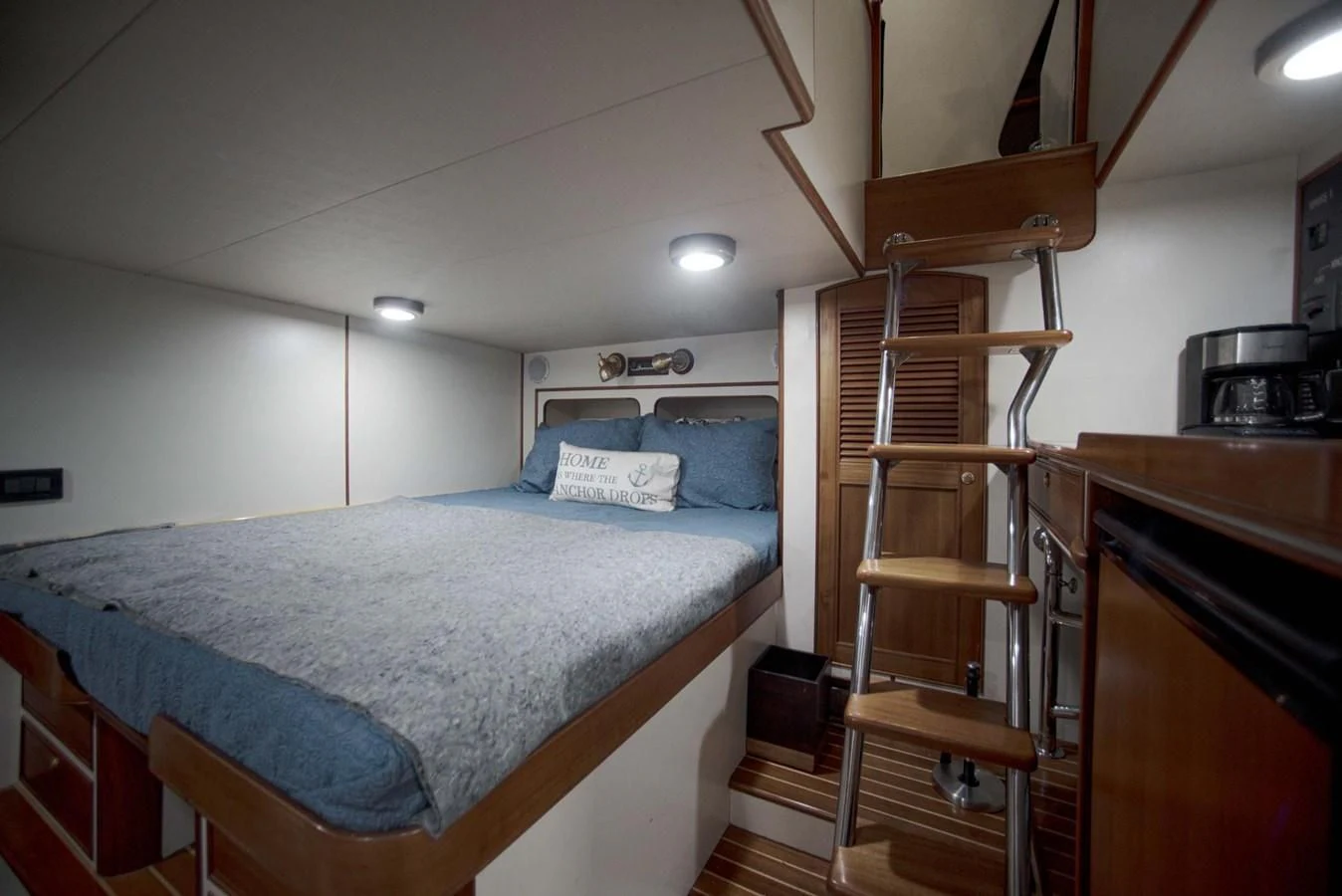 a bedroom with a ladder and a bed aboard JUBILEE Yacht for Sale
