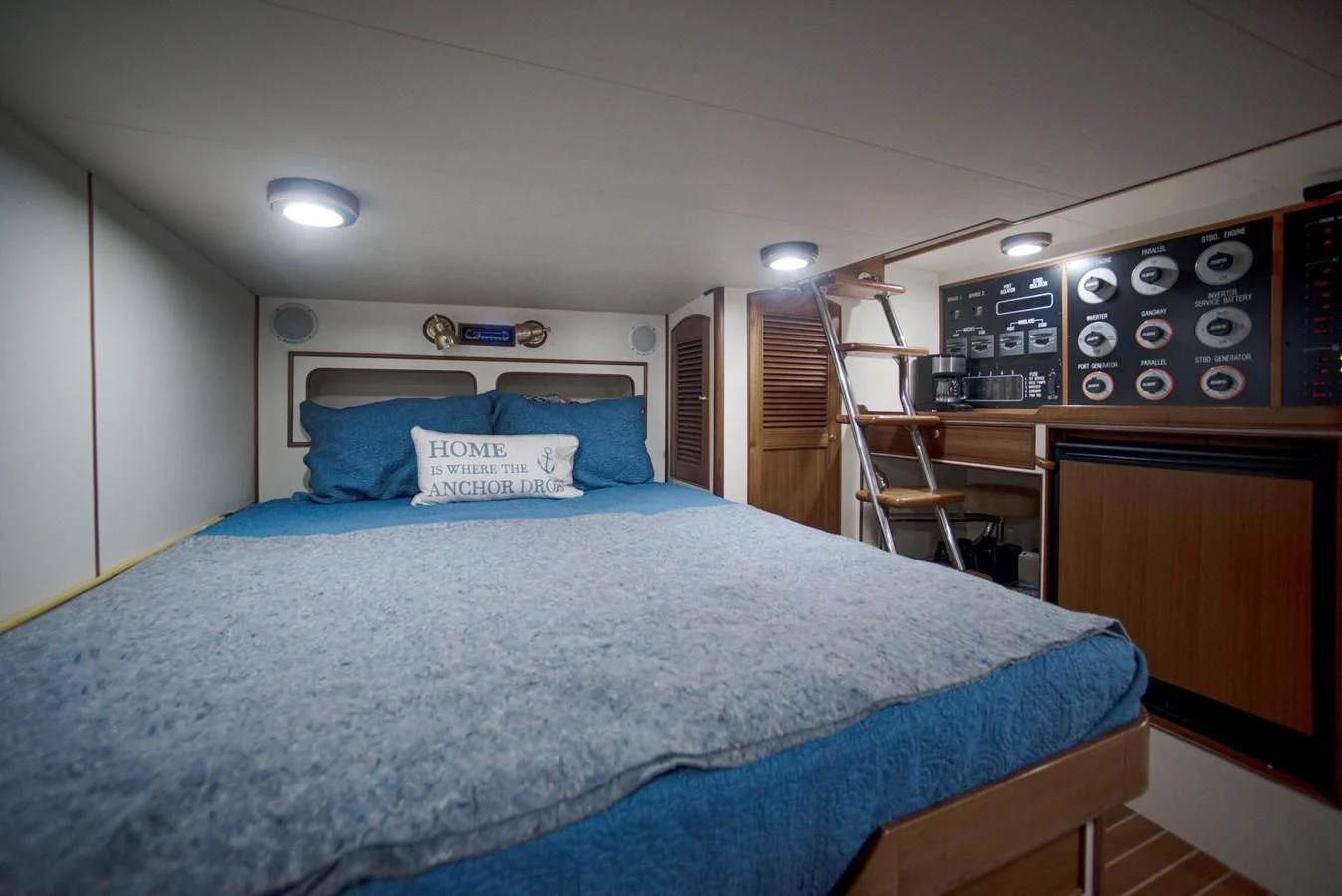 a bed with blue sheets aboard JUBILEE Yacht for Sale