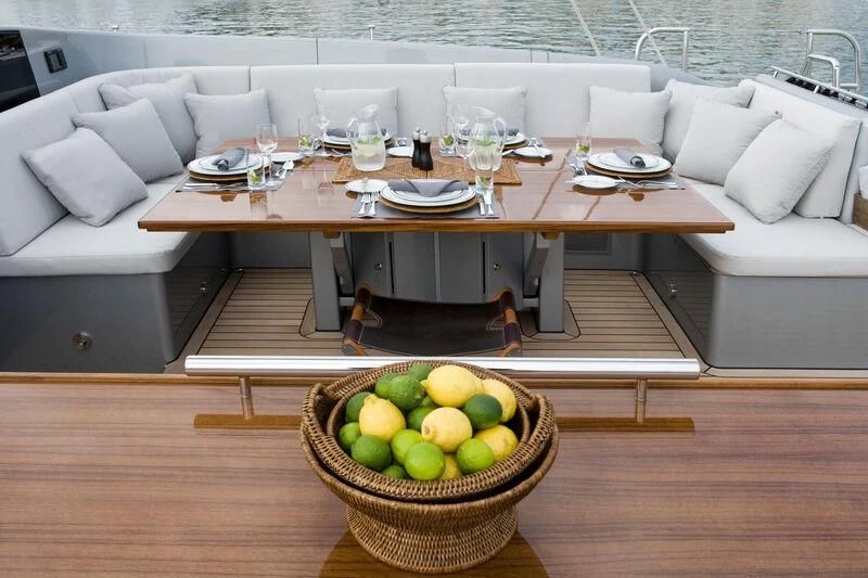 a table with a basket of fruit on it aboard MYSTERE Yacht for Sale
