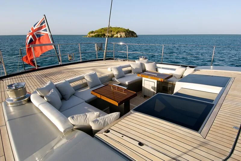 a deck with a chair and a table on it aboard MYSTERE Yacht for Sale