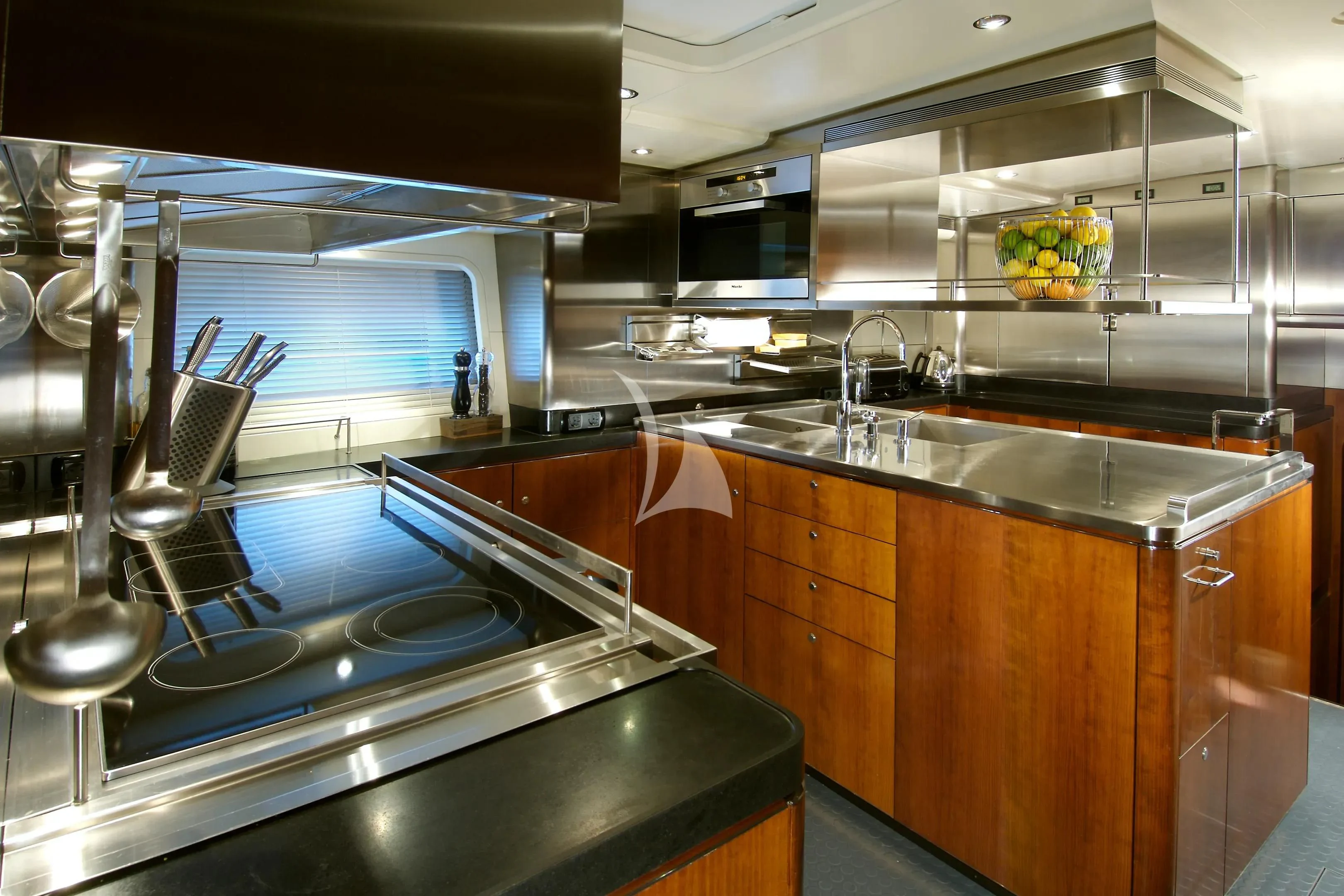 a kitchen with a sink and a large island aboard MYSTERE Yacht for Sale