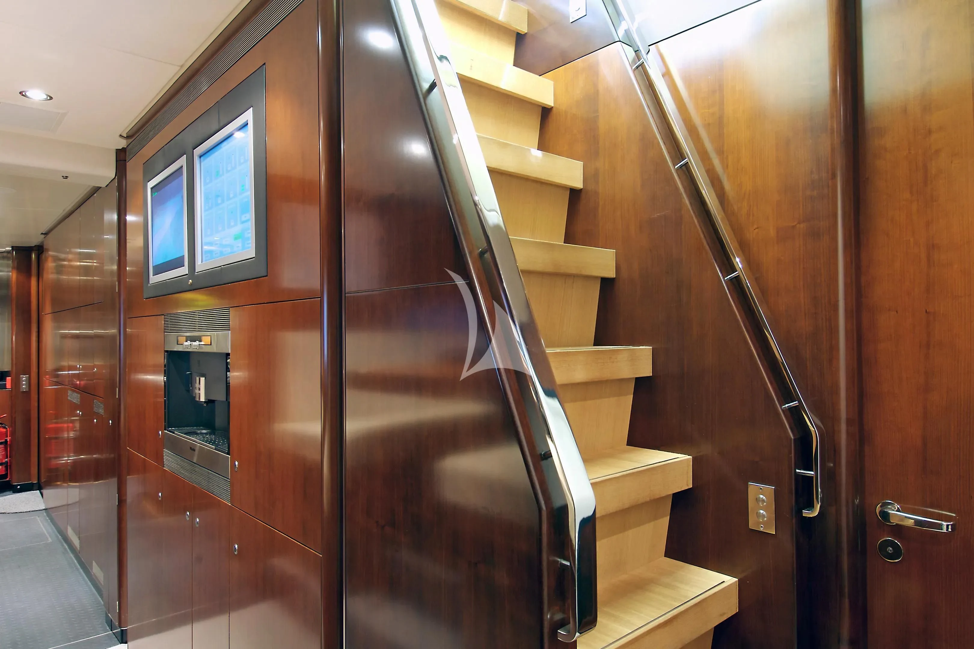 a room with wooden stairs aboard MYSTERE Yacht for Sale
