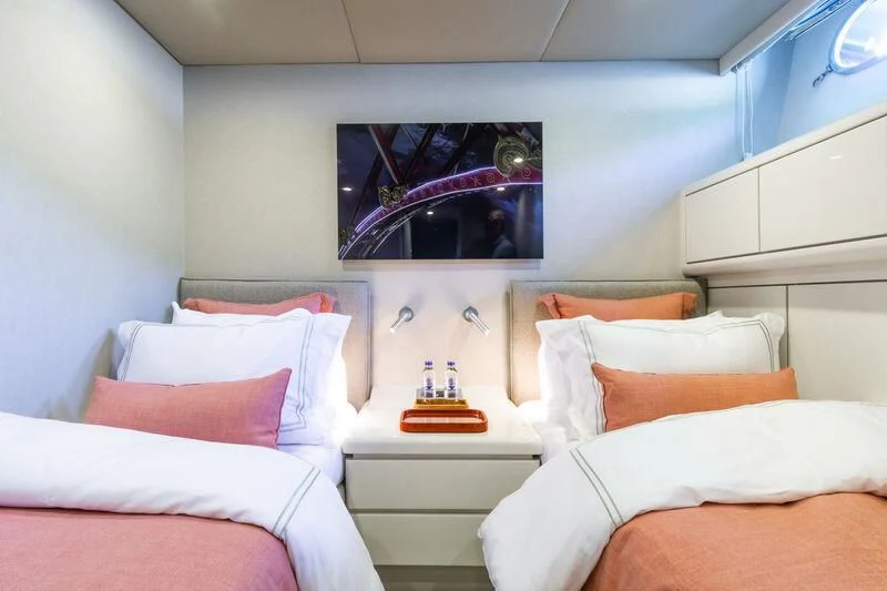 a room with a bed and a television aboard AXELLA Yacht for Sale