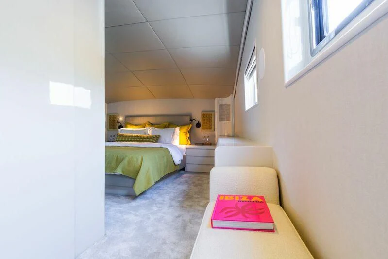 a room with a bed and a couch aboard AXELLA Yacht for Sale