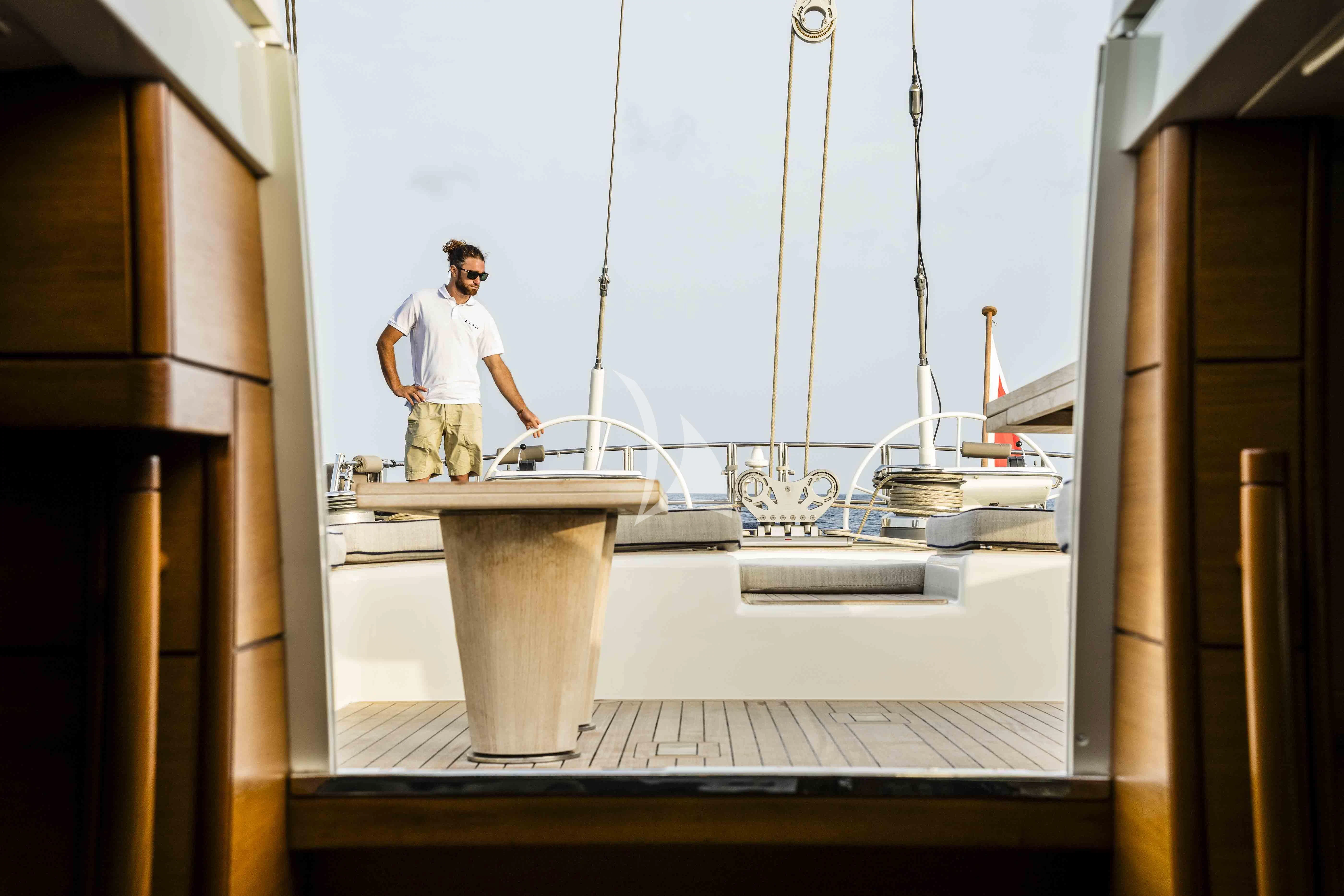 a person standing on a balcony aboard ACAIA Yacht for Sale