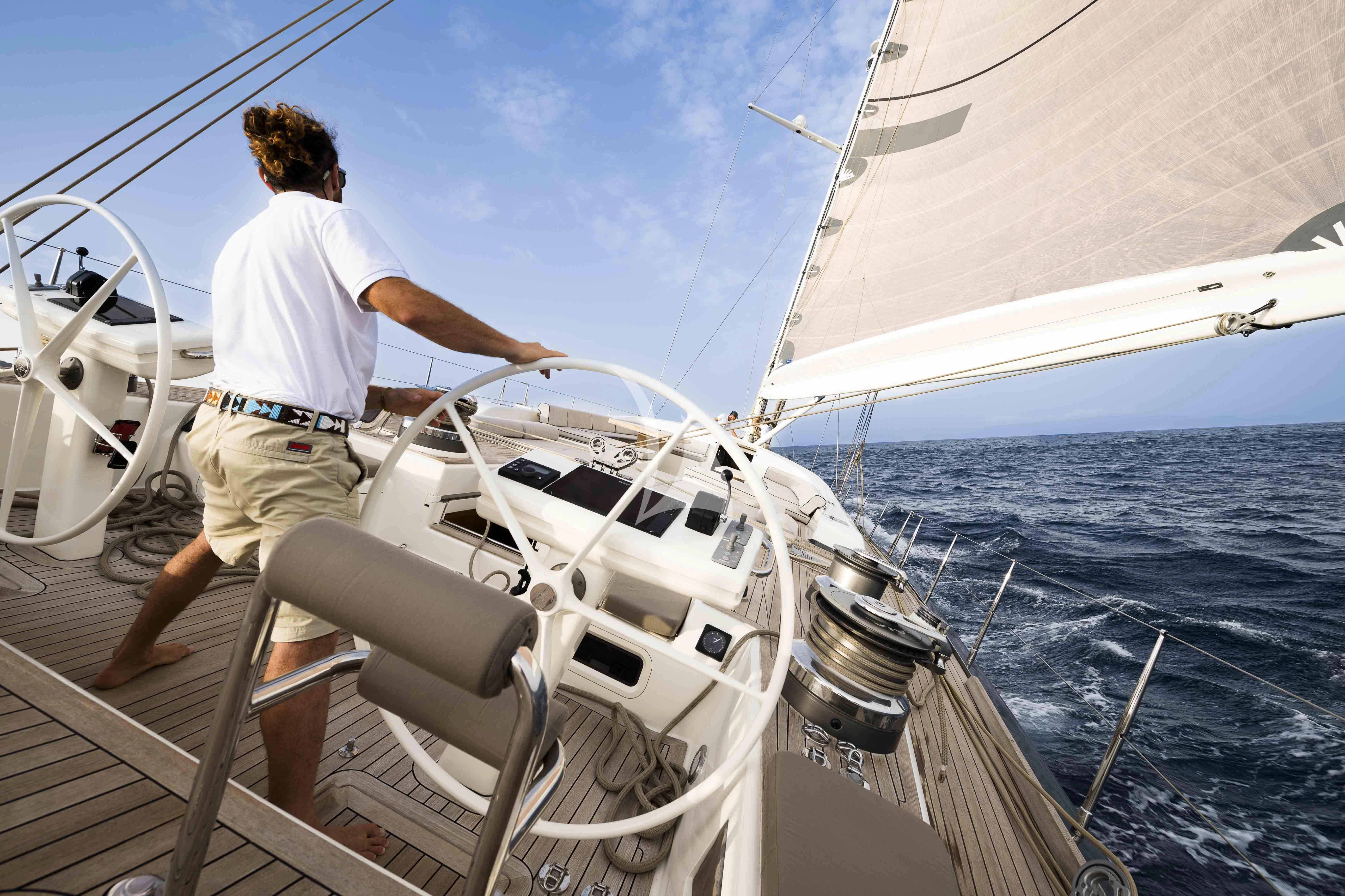 a man on a boat aboard ACAIA Yacht for Sale