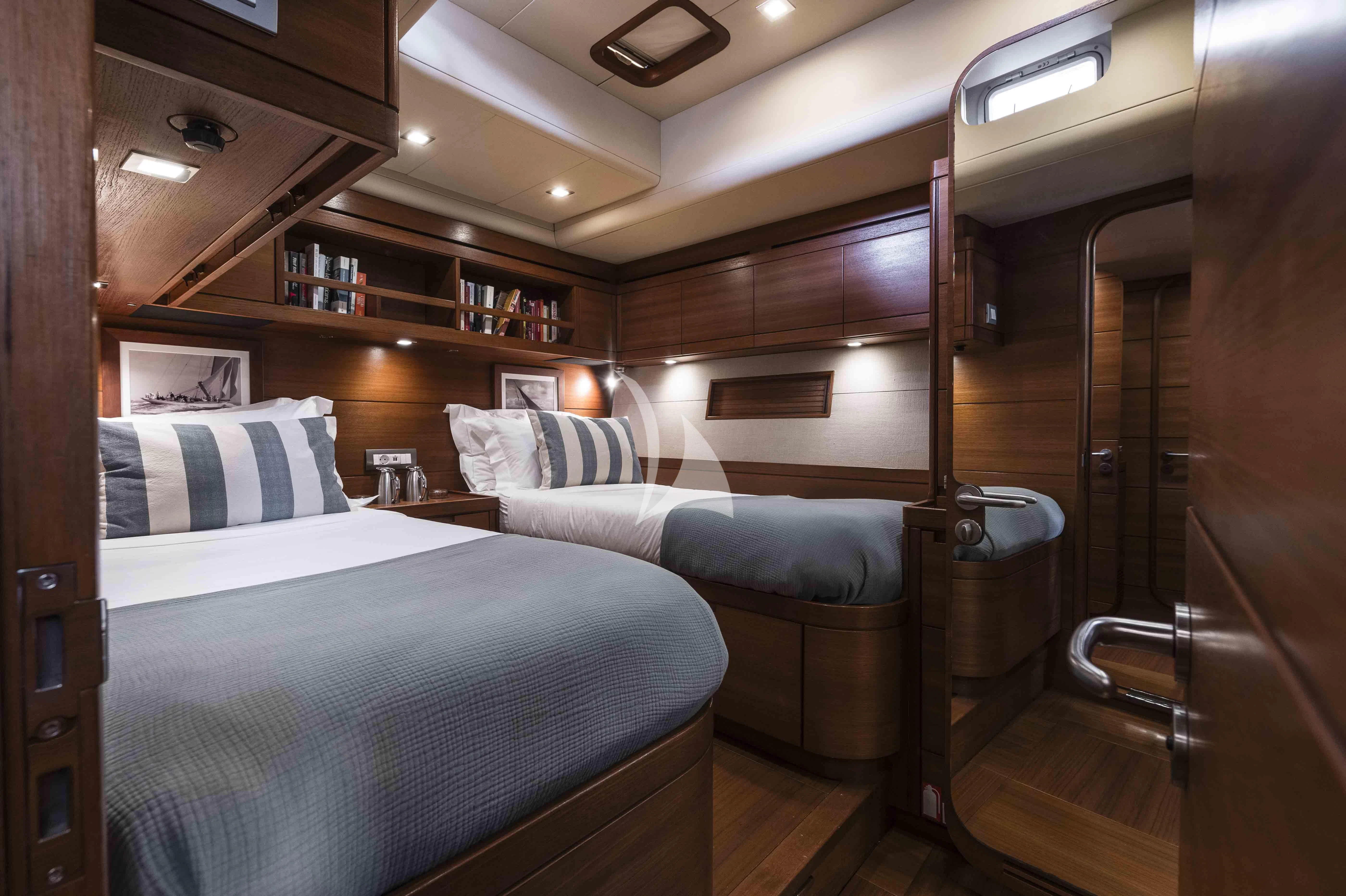 a room with a bed and a couch aboard ACAIA Yacht for Sale