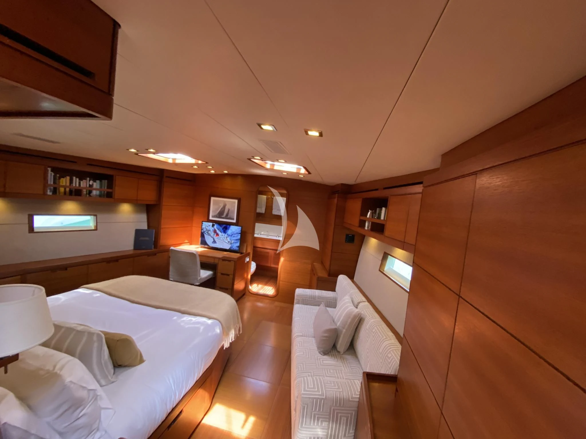 a room with a bed and a television aboard ACAIA Yacht for Sale