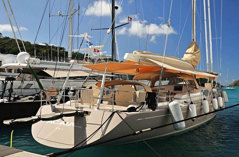 a boat docked at a pier aboard ACAIA Yacht for Sale