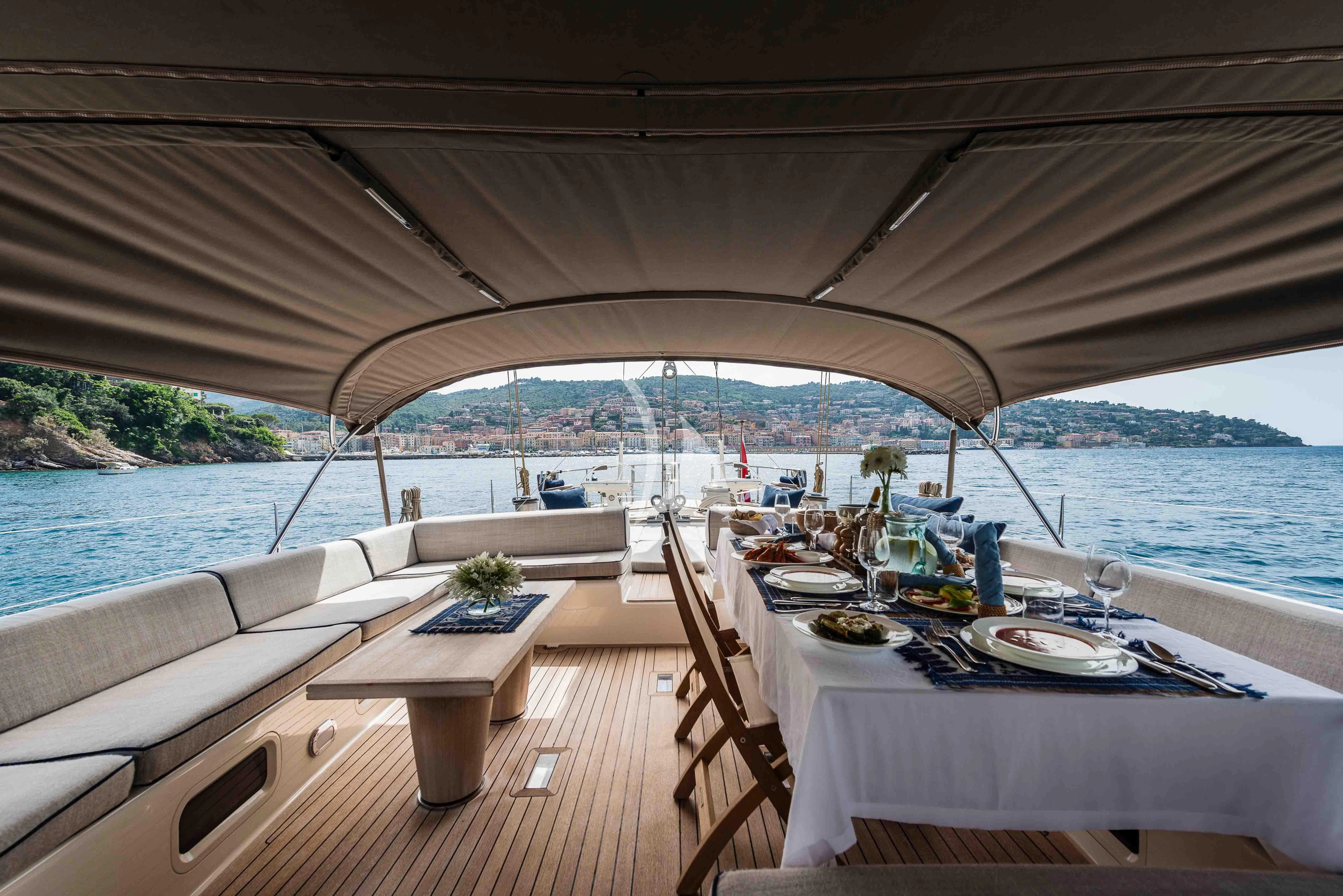 a table set for a meal on a boat aboard ACAIA Yacht for Sale