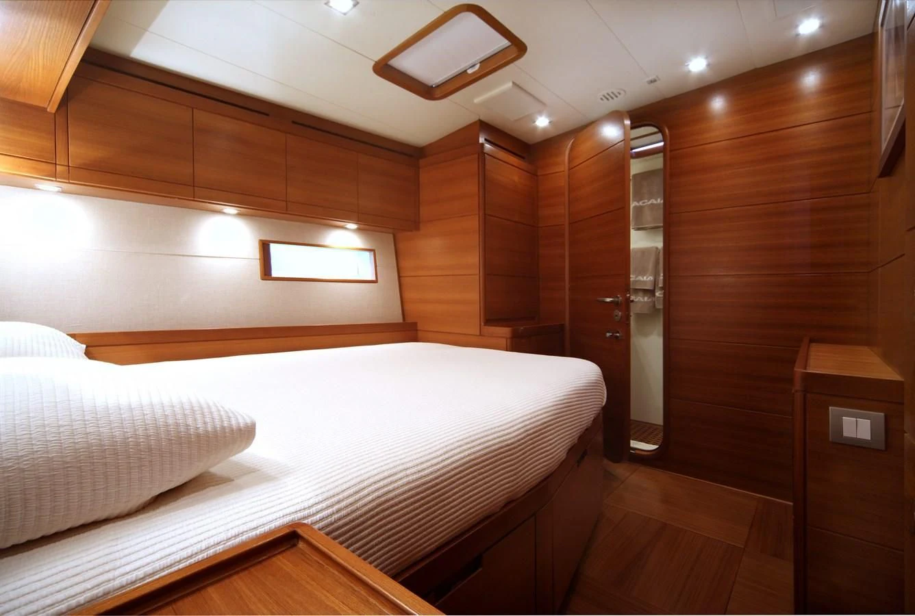 a room with a bed and a wood wall aboard ACAIA Yacht for Sale