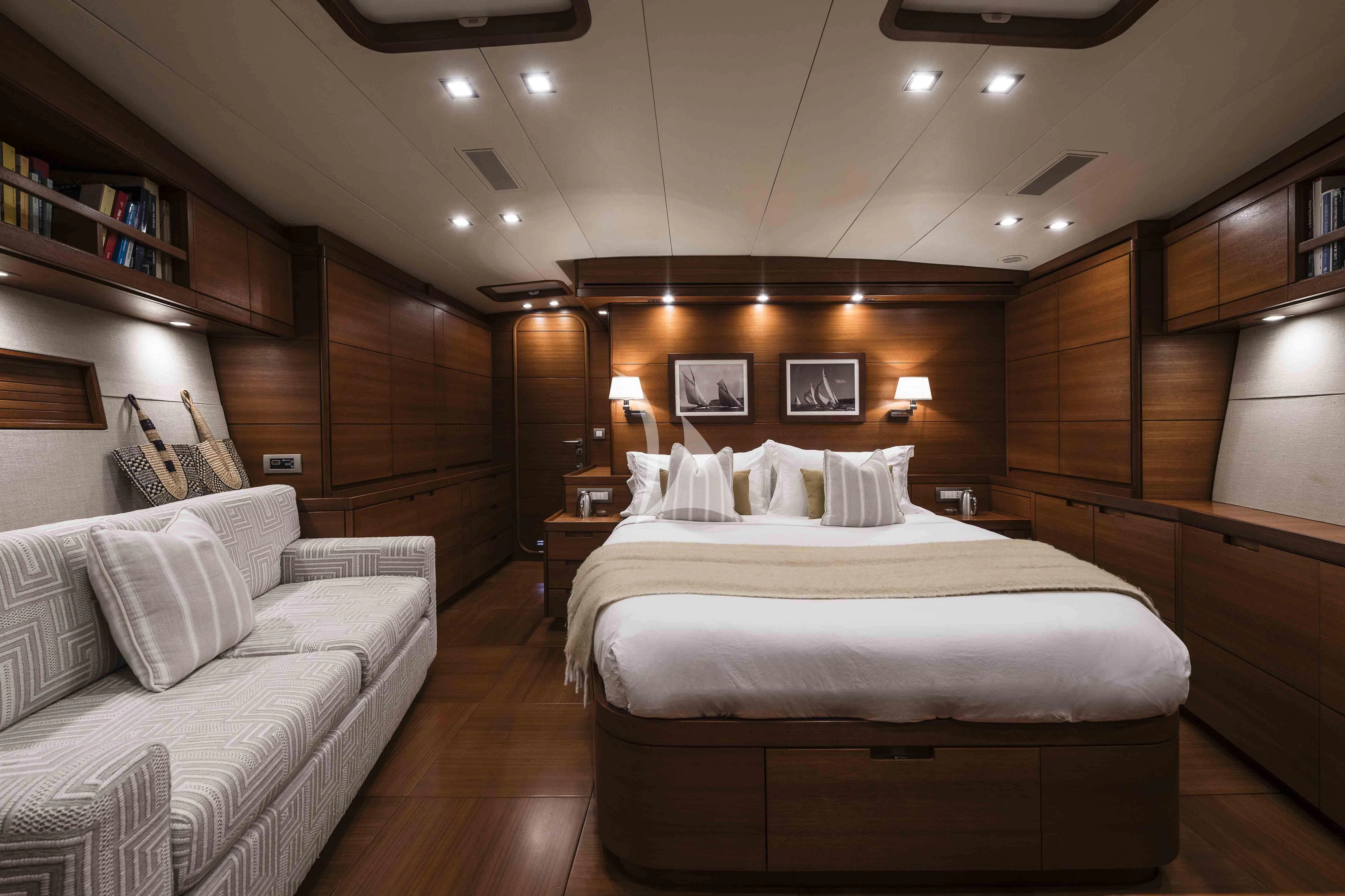 a room with a bed and a couch aboard ACAIA Yacht for Sale