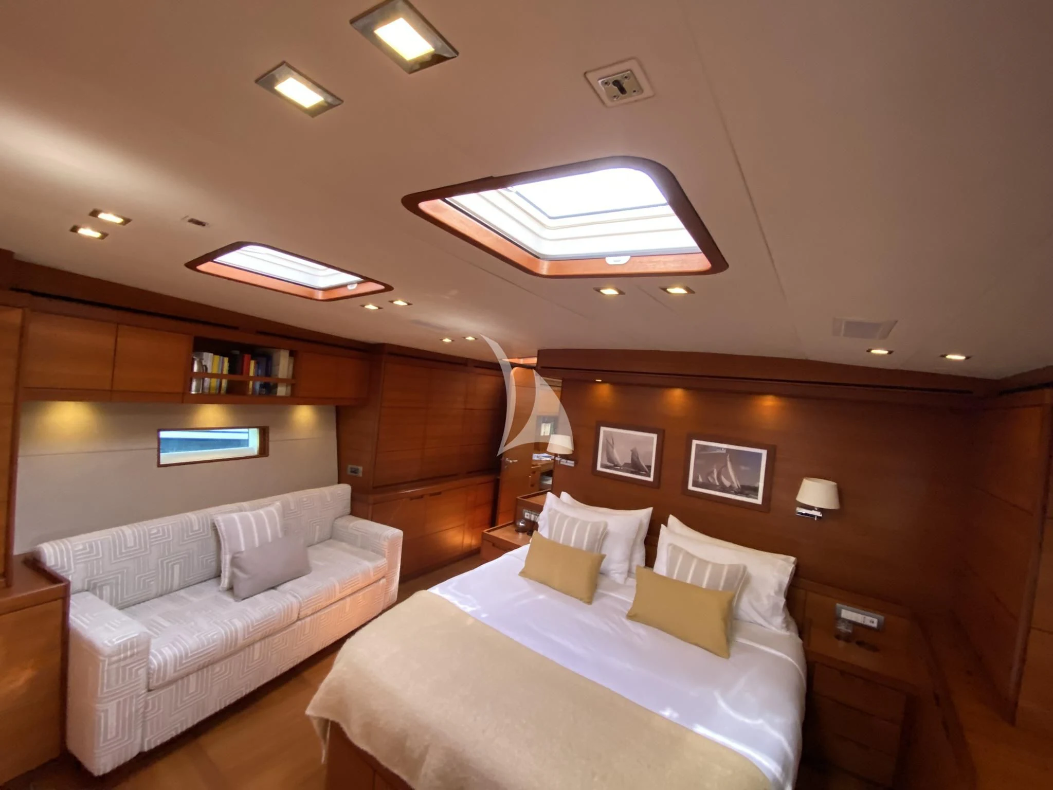 a room with a bed and a couch aboard ACAIA Yacht for Sale