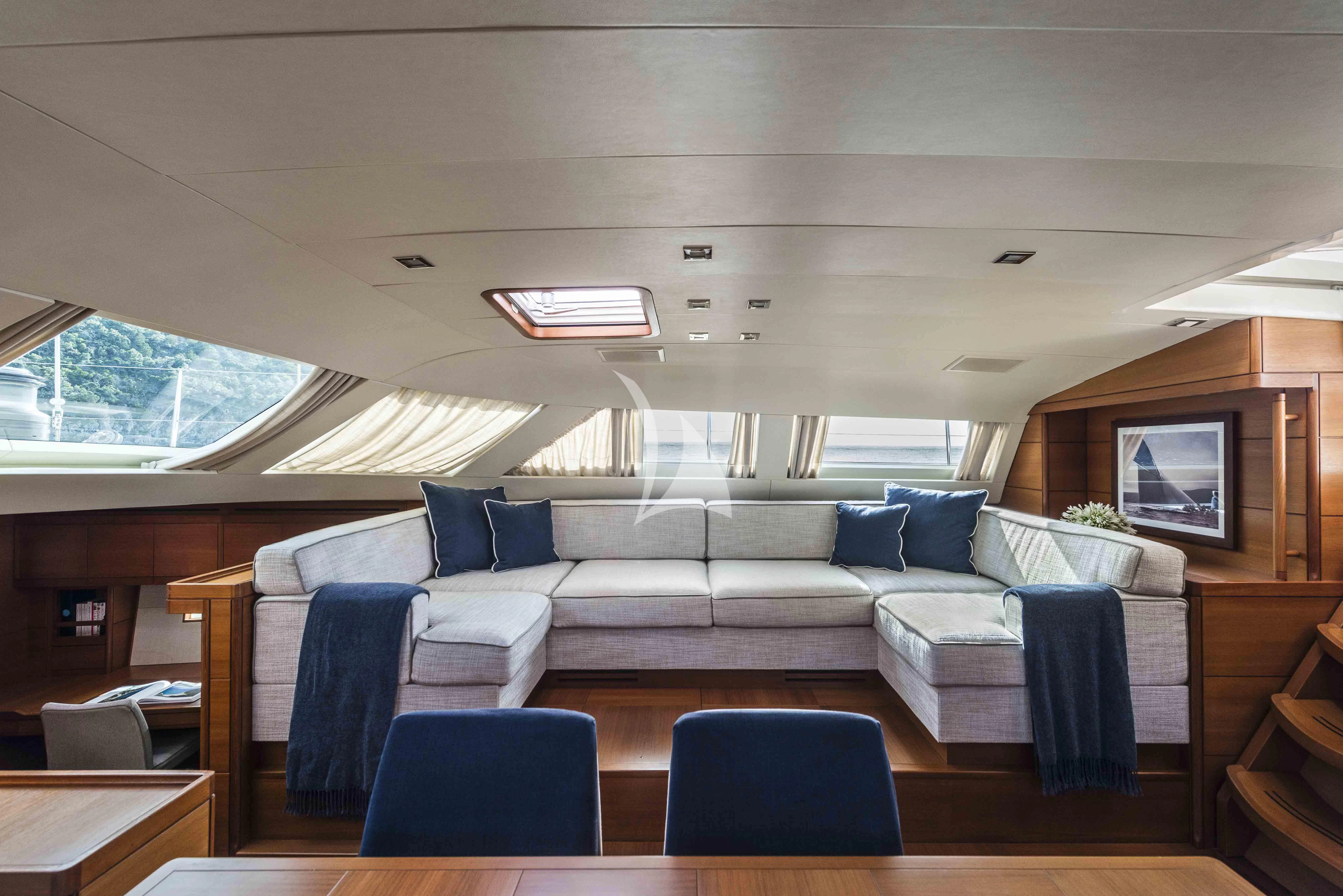 a living room with a couch and a table aboard ACAIA Yacht for Sale