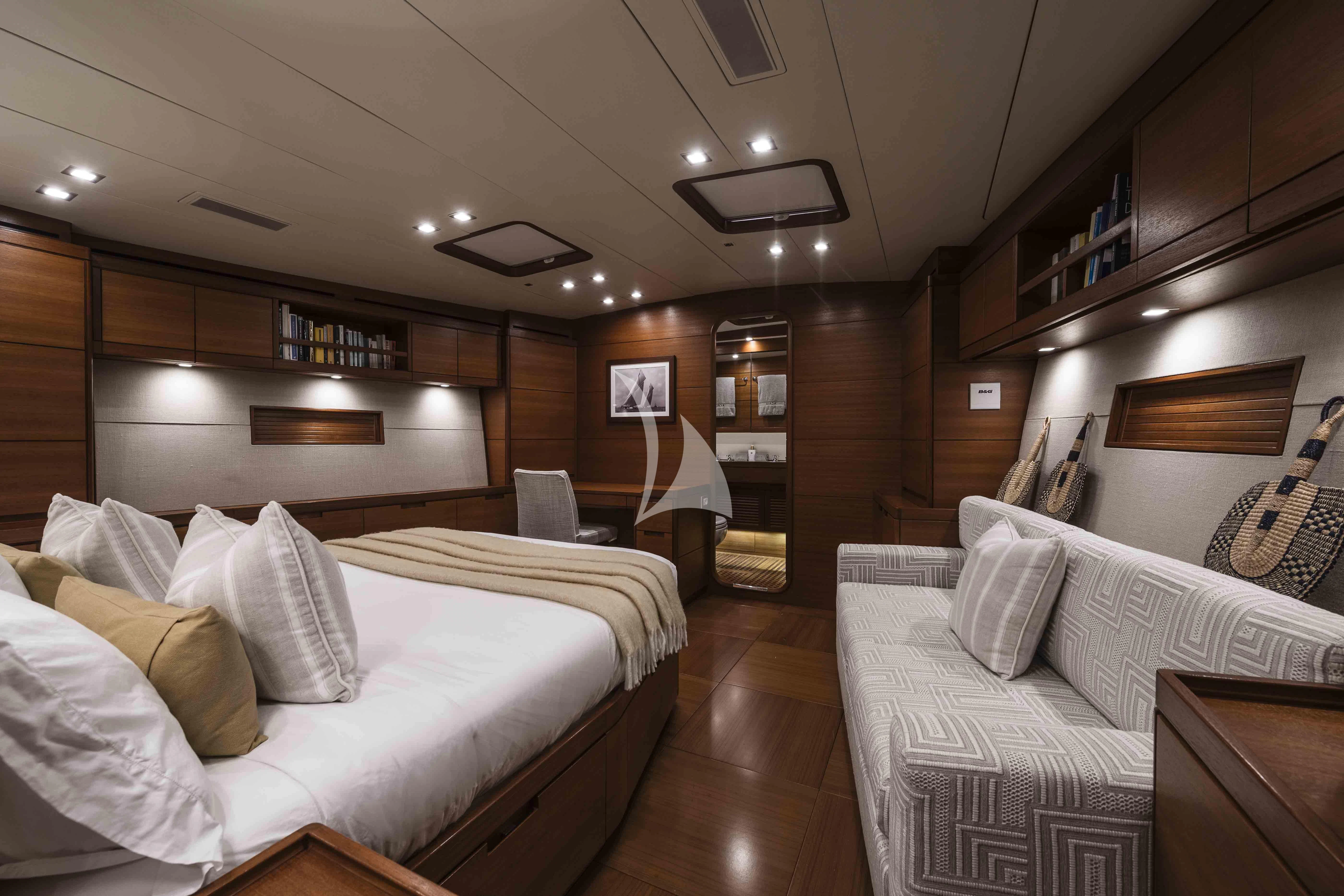 a room with a bed and a couch aboard ACAIA Yacht for Sale