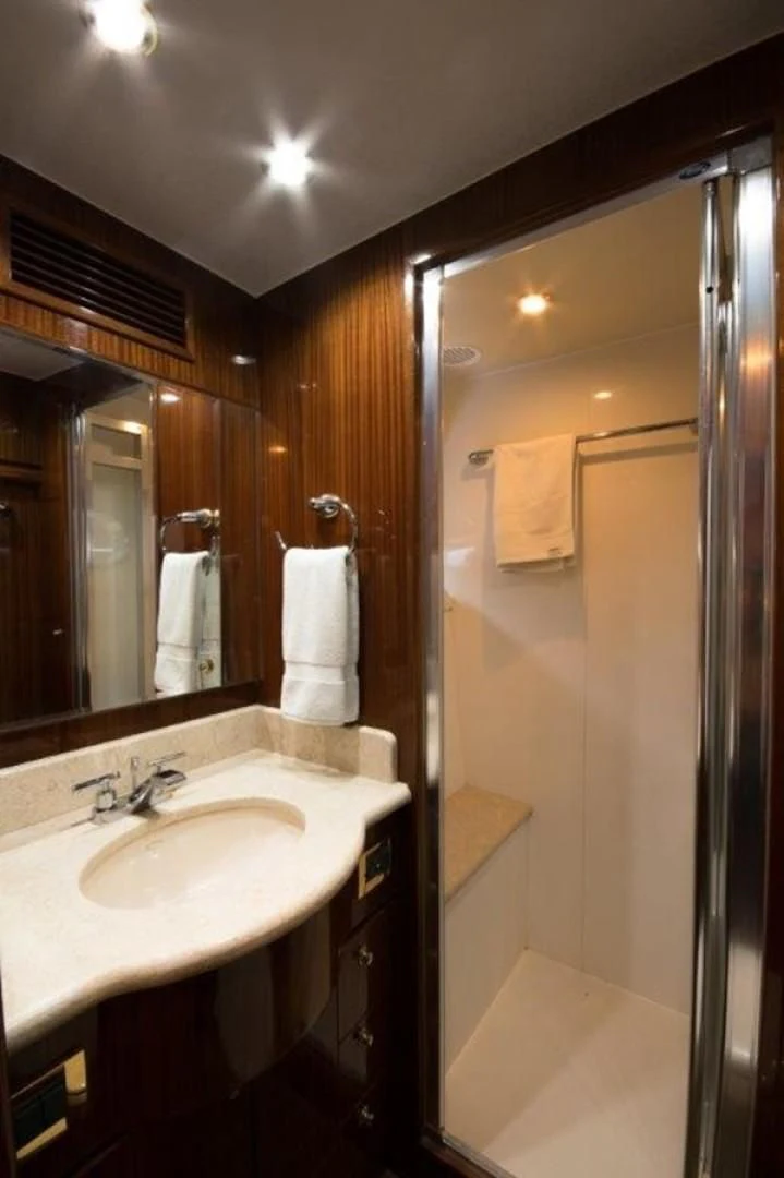 a bathroom with a sink and a shower unit aboard DUNIA Yacht for Sale