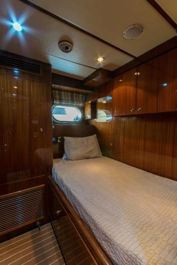 a bed in a room aboard DUNIA Yacht for Sale