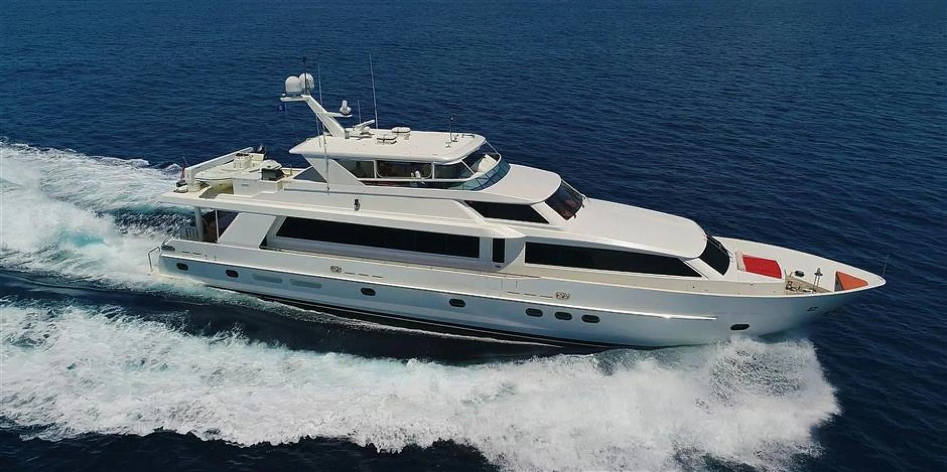 a white yacht on the water aboard DUNIA Yacht for Sale