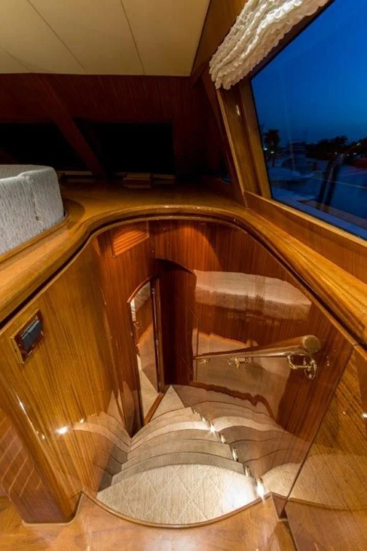 a wooden chair with a seat aboard DUNIA Yacht for Sale