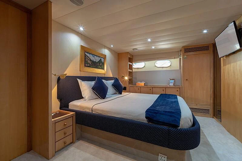 a bedroom with a bed and a desk aboard AJAO Yacht for Sale
