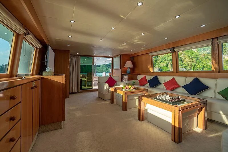 a large living room with a large bed and a table aboard AJAO Yacht for Sale