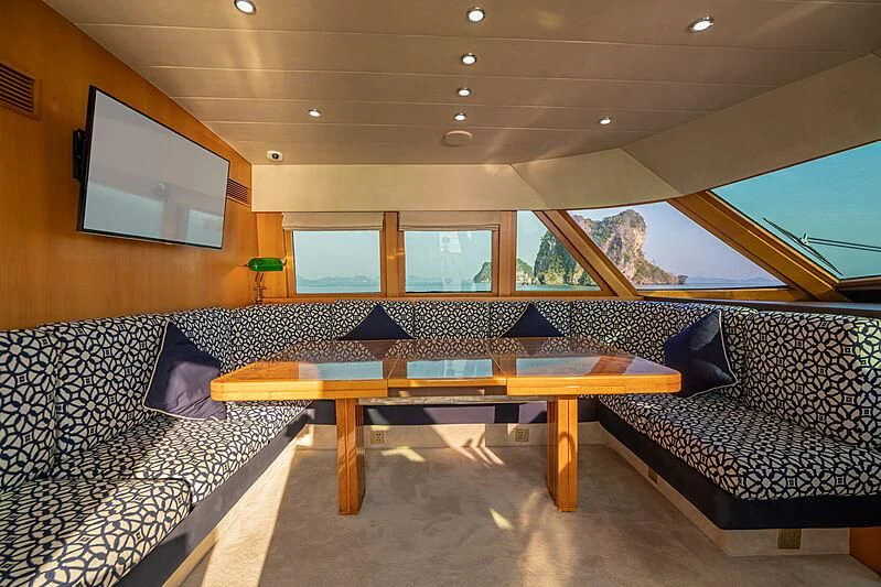 a room with a couch and a television aboard AJAO Yacht for Sale